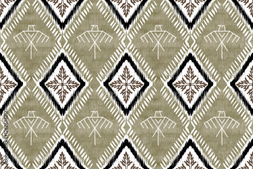 Ikat seamless pattern This Ikat fabric pattern features a tribal-inspired design with a harmonious blend of earthy tones, including olive green, brown, black, and white.