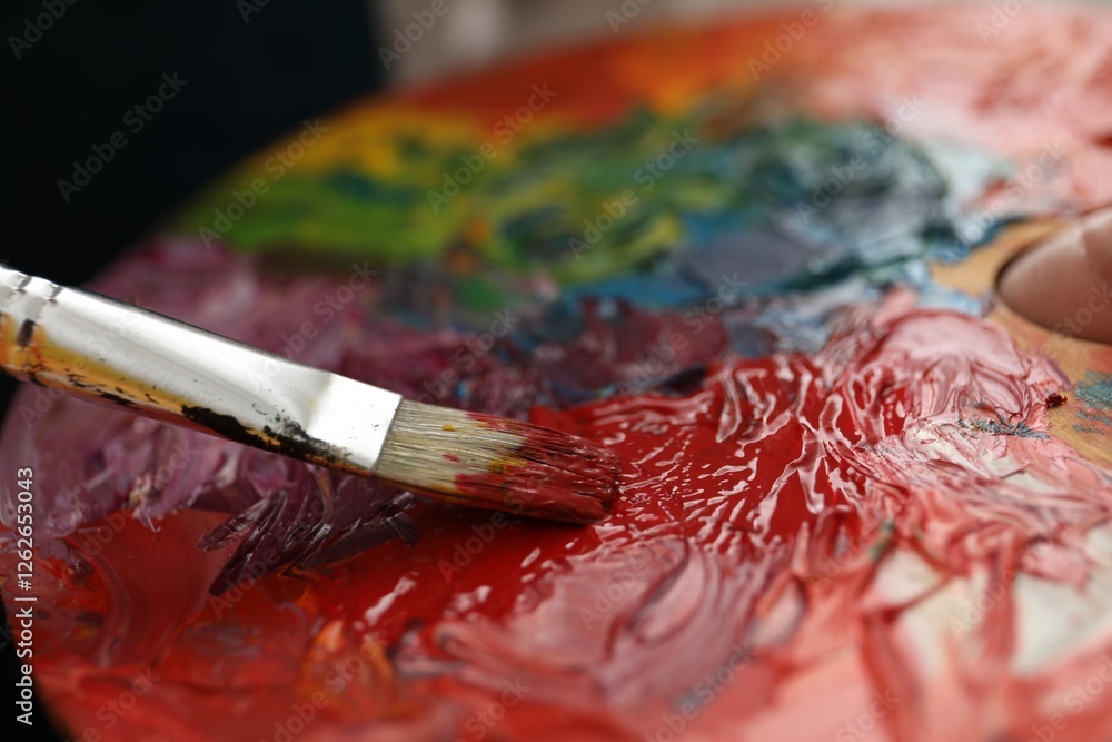 Obraz premium Painting with palette and paintbrush, closeup view