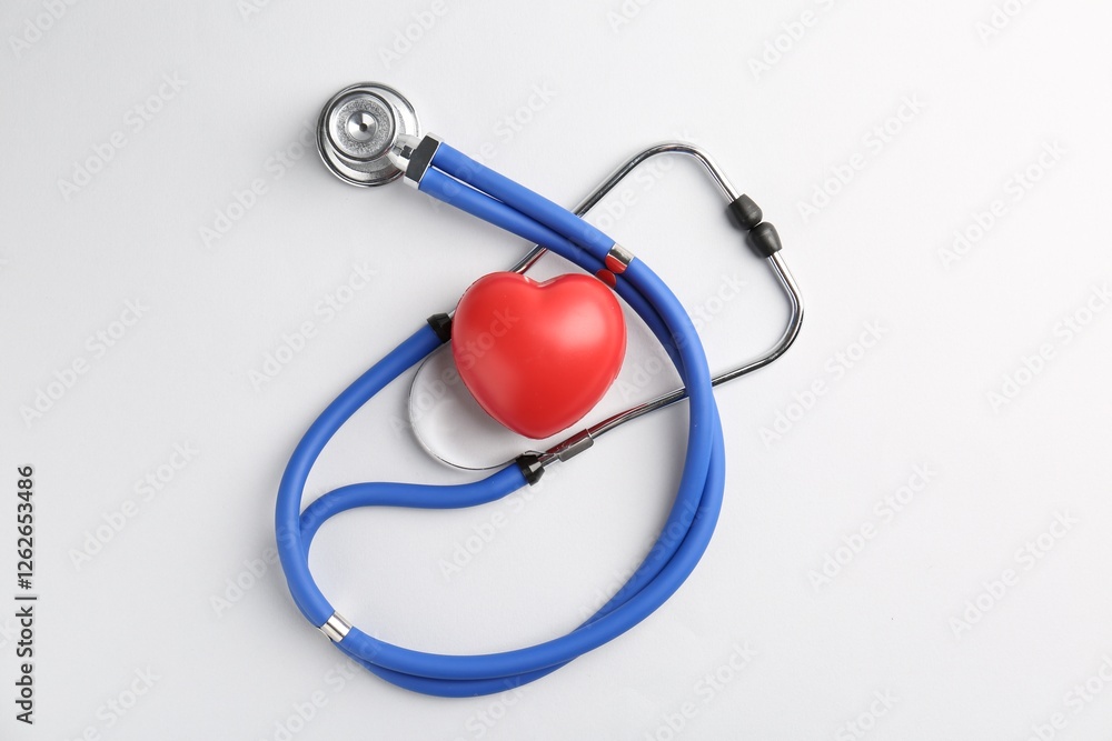 Cardiology. Stethoscope and red decorative heart on white background, flat lay Cardiology. Stethoscope and red decorative heart on white background, flat lay