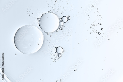 The texture of a cosmetic serum or body gel in a Petri dish.