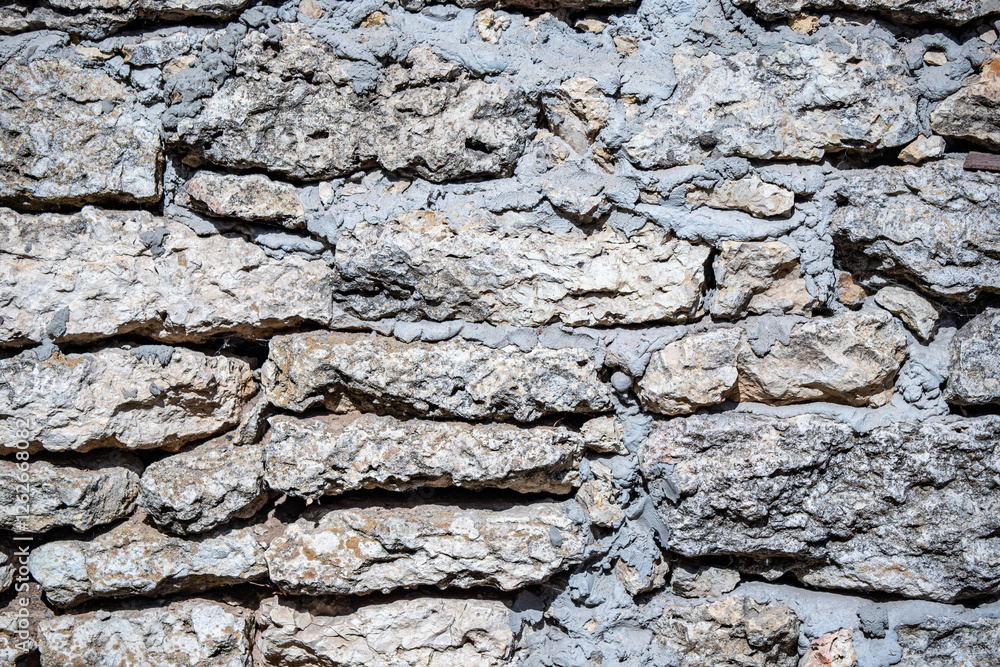 A wall made of stone with a rough texture A wall made of stone with a rough texture