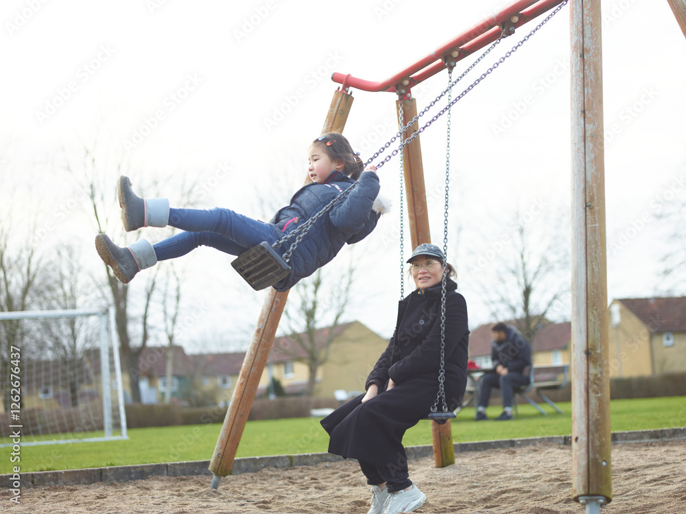little girl playing on the swing little girl playing on the swing