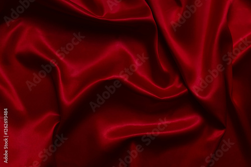 The top view of the red satin surface looks luxurious and beautiful. with sparkling waves Abstract background design copy space Card or banner (blurred or blurry)