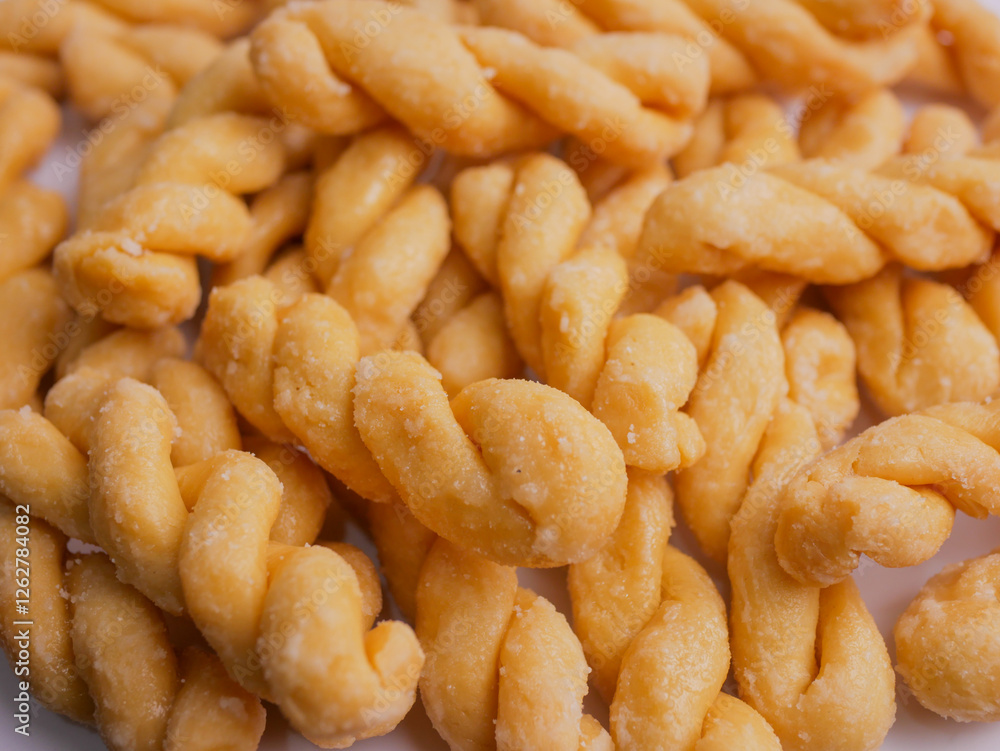 Kue untir-untir or kue tambang isolated on white background, untir untir is a traditional Indonesian deep-fried twisted doughnut that has a sweet and crunchy taste, snack, cookies, crispy, delicious Kue untir-untir or kue tambang isolated on white background, untir untir is a traditional Indonesian deep-fried twisted doughnut that has a sweet and crunchy taste, snack, cookies, crispy, delicious