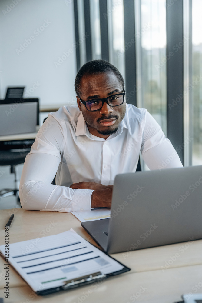 Using laptop. Businessman is working in modern office
