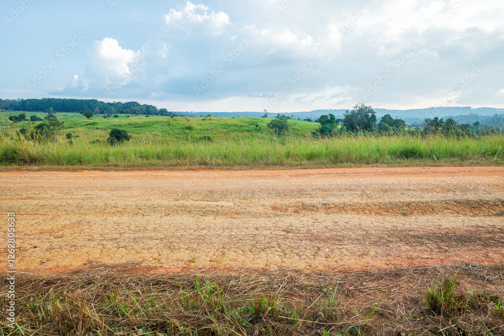 Obraz premium Landscape of gravel road in countryside. Road in rainy season. Side view of dirt road on top mountain. road background.