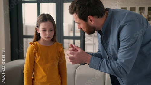 Angry stressed irritated Caucasian guy scold anxious rebellious kid little child schoolgirl man dad male scream at daughter girl at home argument father speaking parent shouting family quarrel problem