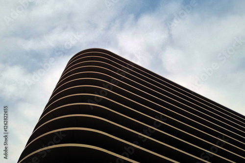 Modern Architectural Curves Against a Cloudy Sky - Perfect for Design and Print
