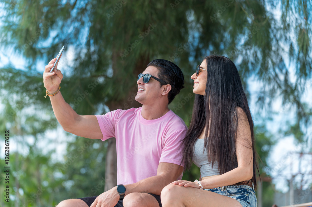 Young Lover Man take vdo call with woman they are very happy and smile in outdoor background enjoy at the beach - summer vacation on sea beach concept