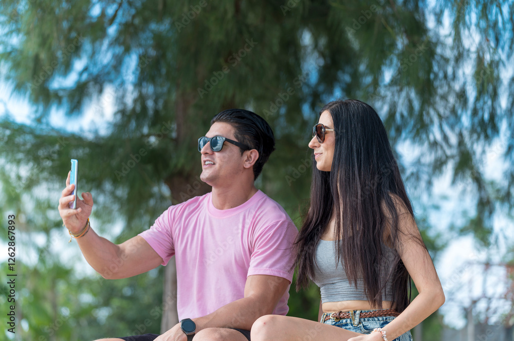 Young Lover Man take vdo call with woman they are very happy and smile in outdoor background enjoy at the beach - summer vacation on sea beach concept
