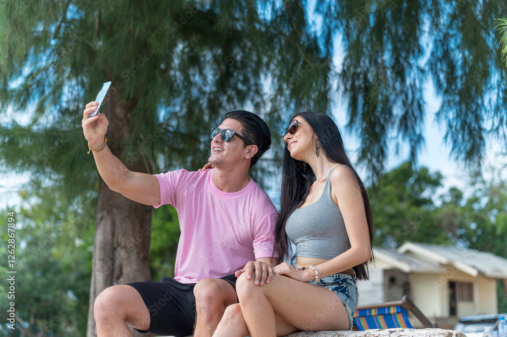 Young Lover Man take vdo call with woman they are very happy and smile in outdoor background enjoy at the beach - summer vacation on sea beach concept