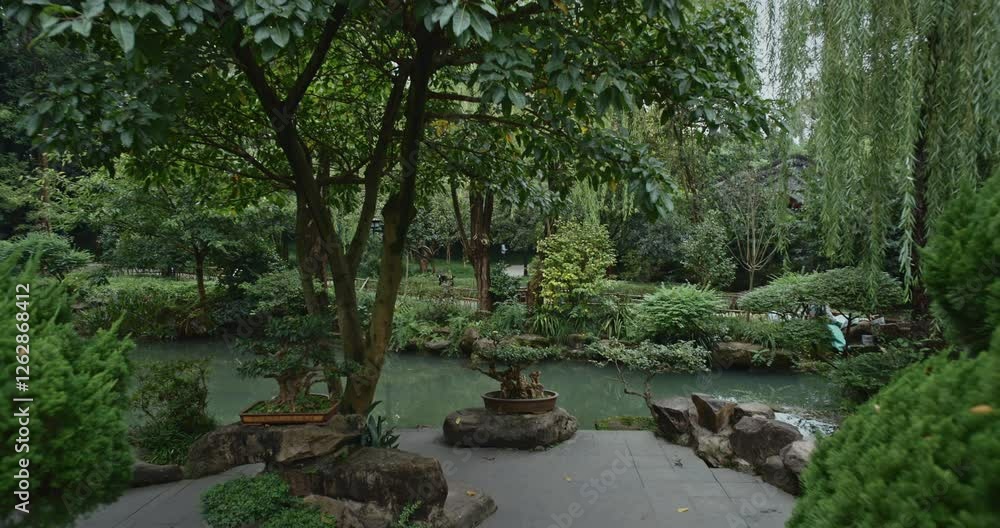 Chengdu, Sichuan, China. Garden Area Of Wuhou Memorial Temple. Ornamental Bonsai Tree. Green Foliage Bushes. Comfortable Environment To Embrace Nature. Silence And Peace. Zen-like Concept Chengdu, Sichuan, China. Garden Area Of Wuhou Memorial Temple. Ornamental Bonsai Tree. Green Foliage Bushes. Comfortable Environment To Embrace Nature. Silence And Peace. Zen-like Concept