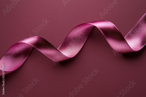 Elegant Burgundy Ribbon Draped on a Solid Background