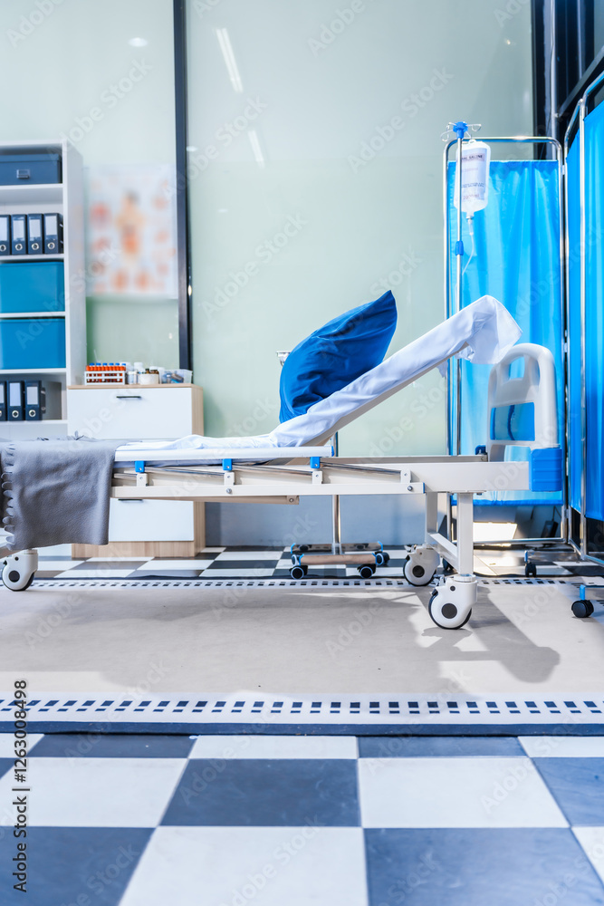 An empty medical bed sits in a glass hospital room, bathed in daylight. Equipped with adjustable features, it awaits the next patient, essential medical equipment for emergency and critical care. An empty medical bed sits in a glass hospital room, bathed in daylight. Equipped with adjustable features, it awaits the next patient, essential medical equipment for emergency and critical care.