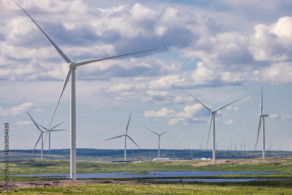 wind turbines in a field against a background of blue sky with clouds, wind farm, Kola peninsula, power plant, windmill