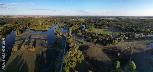 Sunset landscape flooded river Dyje Thaya water reflection aerial drone view panorama lake seasonal meadow green shadows trees horizon blue sky Czech Republic protected area  Pohansko Soutok photo