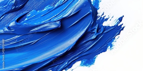 Glossy blue paint elegantly splashed against a pristine white backdrop, creating a dynamic interplay of smooth textures and vibrant contrasts photo