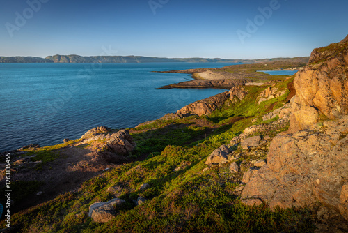 the coast of the Barents Sea near the village of Teriberka in the evening on a polar day photo