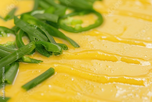 Close-up of fresh sliced green onions on soft yellow background photo