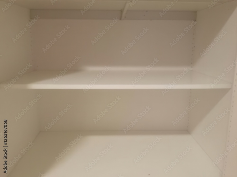 Empty white shelves in a minimalist interior space Empty white shelves in a minimalist interior space