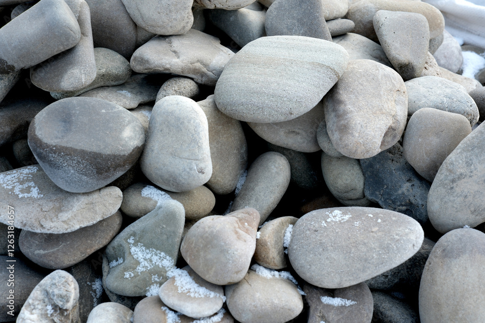 Smooth river stones create a natural mosaic in soft gray hues Smooth river stones create a natural mosaic in soft gray hues