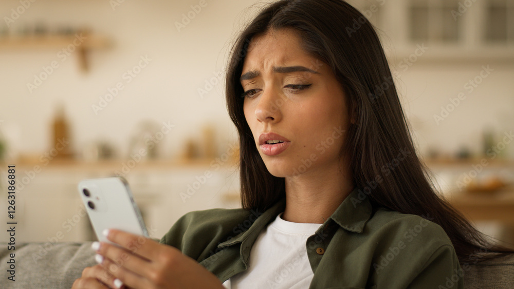 Upset sad frustrated disappointed confused puzzled Indian woman Arabian girl female Muslim lady at home couch sofa looking mobile phone smartphone social media app worry bad news failure lost online Upset sad frustrated disappointed confused puzzled Indian woman Arabian girl female Muslim lady at home couch sofa looking mobile phone smartphone social media app worry bad news failure lost online