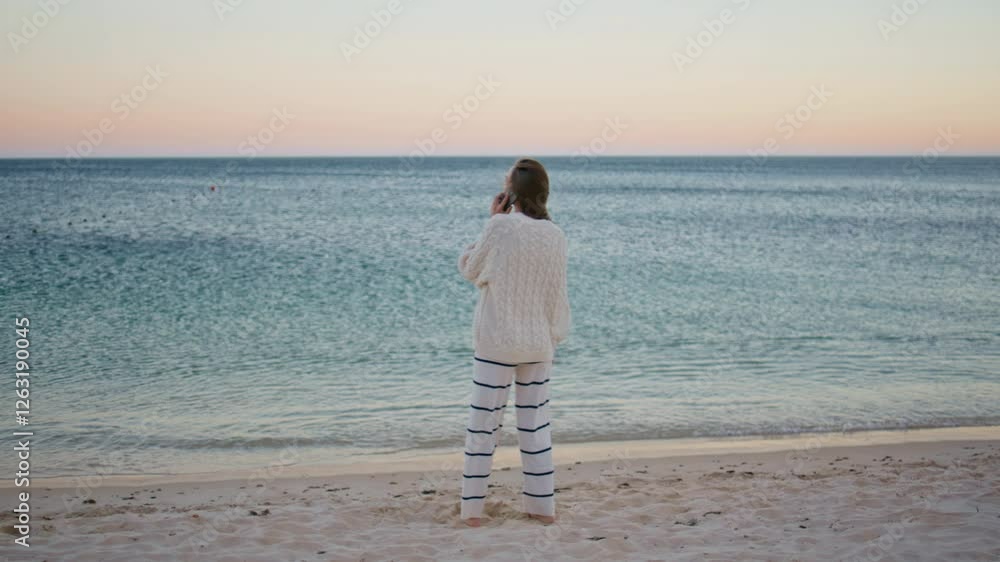 Carefree woman calling beach looking at beautiful ripple ocean waves at evening. Carefree woman calling beach looking at beautiful ripple ocean waves at evening.