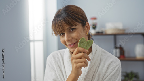 Photography Hispanic woman in spa holding jade stone in wellness center with shelves in the