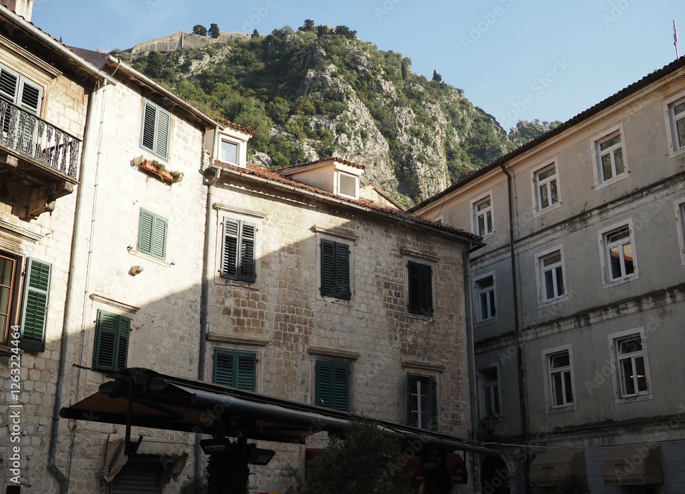 Fototapeta premium Narrow cozy sunny beige streets of Kotor, Montenegro, Balkans. Historical center of the old town
