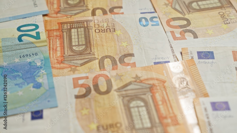Euro banknotes from the european union featuring 50 and 20 euro denominations scattered on a surface Euro banknotes from the european union featuring 50 and 20 euro denominations scattered on a surface