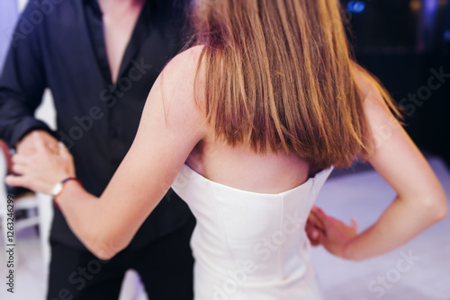 High school graduates dancing on prom, waltz and classical ball slow dance in dresses and suits on school graduation party, boys and girls ballroom dancers, couples dance quadrille and polonaise photo