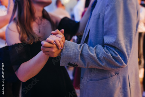 High school graduates dancing on prom, waltz and classical ball slow dance in dresses and suits on school graduation party, boys and girls ballroom dancers, couples dance quadrille and polonaise photo