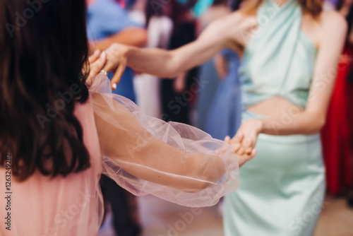 High school graduates dancing on prom, waltz and classical ball slow dance in dresses and suits on school graduation party, boys and girls ballroom dancers, couples dance quadrille and polonaise photo