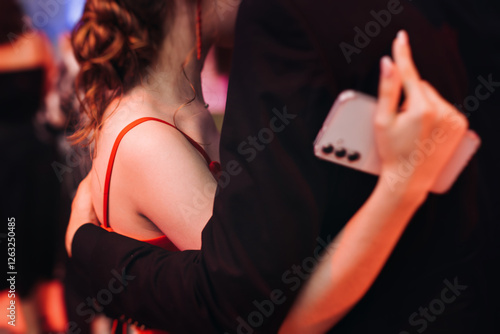 High school graduates dancing on prom, waltz and classical ball slow dance in dresses and suits on school graduation party, boys and girls ballroom dancers, couples dance quadrille and polonaise photo