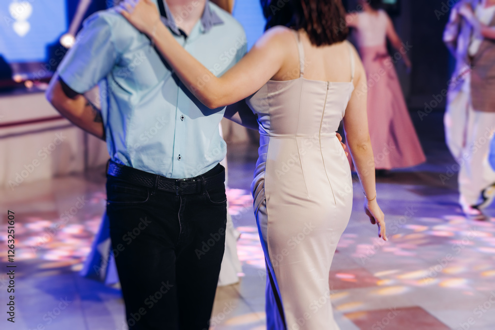 Obraz premium High school graduates dancing on prom, waltz and classical ball slow dance in dresses and suits on school graduation party, boys and girls ballroom dancers, couples dance quadrille and polonaise