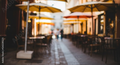 Blurred outdoor cafe scene with empty tables and sun umbrellas in european street