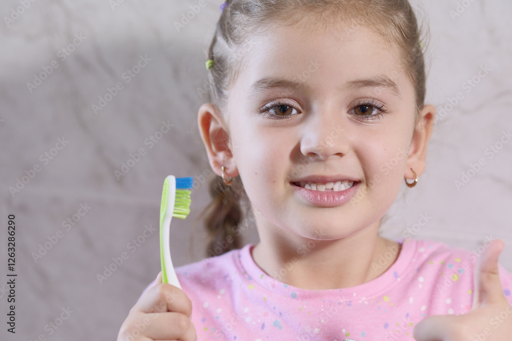 5-year-old girl playing with her toothbrush after brushing her teeth 5-year-old girl playing with her toothbrush after brushing her teeth