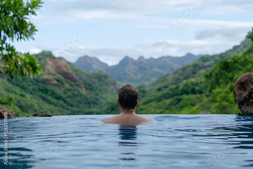 Man relaxing in pool overlooking mountains. Scenery provides calm, vacation escape. Generative AI