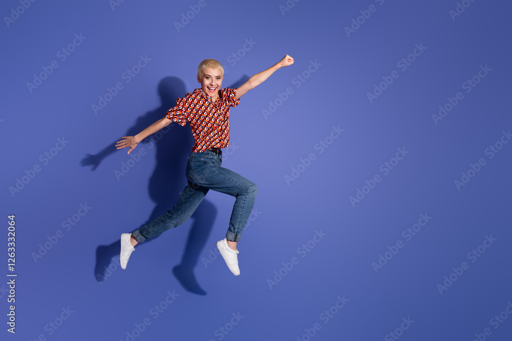 Cheerful young woman jumping mid-air over a vibrant purple backdrop emphasizing energy and positivity Cheerful young woman jumping mid-air over a vibrant purple backdrop emphasizing energy and positivity