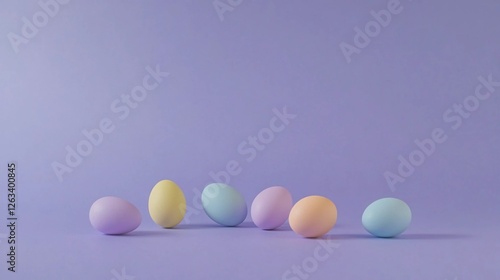 Colorful pastel eggs arranged on a light purple background for a festive celebration or seasonal decoration
