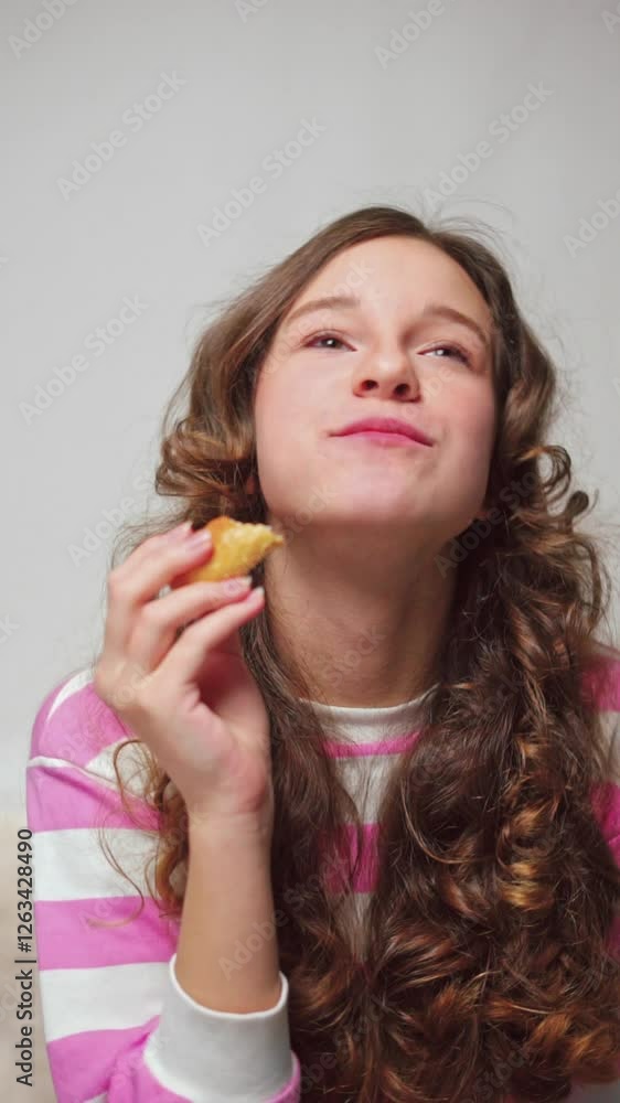 Vertical video of a joyful girl with wavy hair enjoying a delicacy Vertical video of a joyful girl with wavy hair enjoying a delicacy