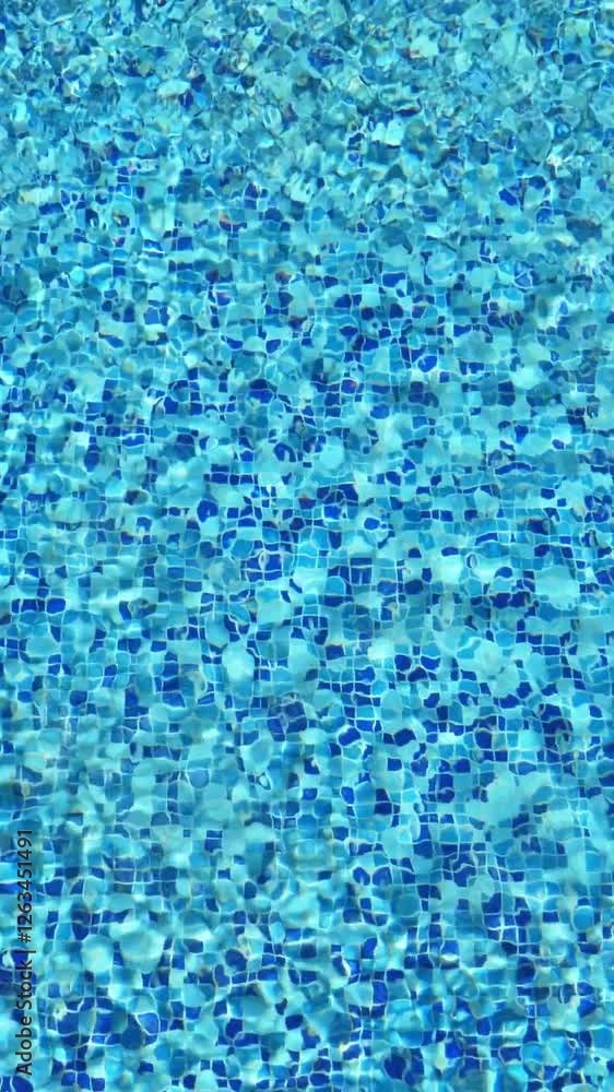 Clean blue water in swimming pool with reflections, nobody. Vertical footage Clean blue water in swimming pool with reflections, nobody. Vertical footage