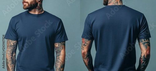 A man with tattoos wearing a plain navy blue t-shirt