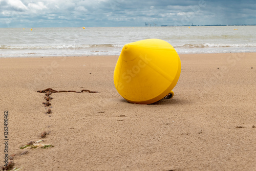 toys in yellow for the boats and ships with chain on the beach