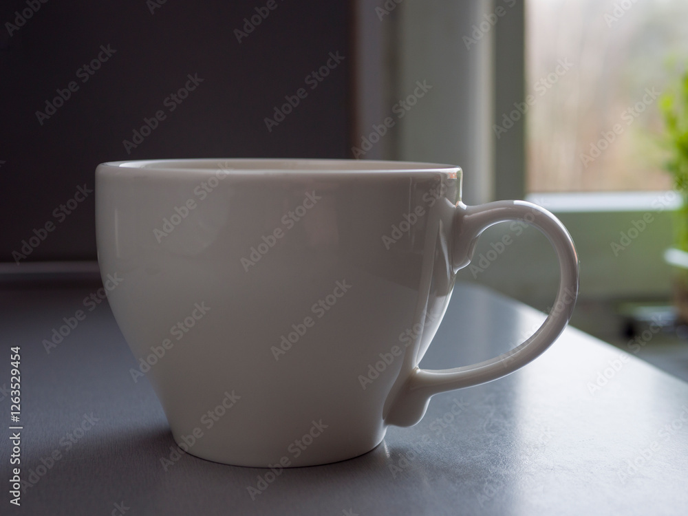 Large white mug brimming with steaming coffee rests on a table beside a window, basking in natural light and creating a warm, inviting atmosphere perfect for morning relaxation Large white mug brimming with steaming coffee rests on a table beside a window, basking in natural light and creating a warm, inviting atmosphere perfect for morning relaxation