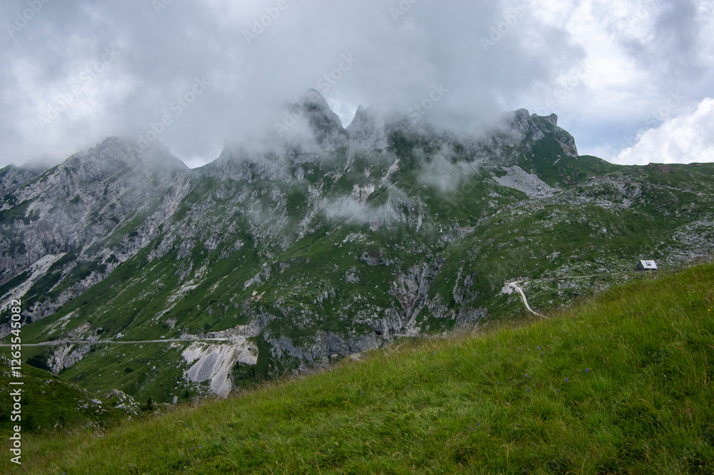Mala Spice Cime Verdi peaks view from Mangart saddle, Slovenia's Highest Panoramic Road, heavy clouds before rain, foggy day
