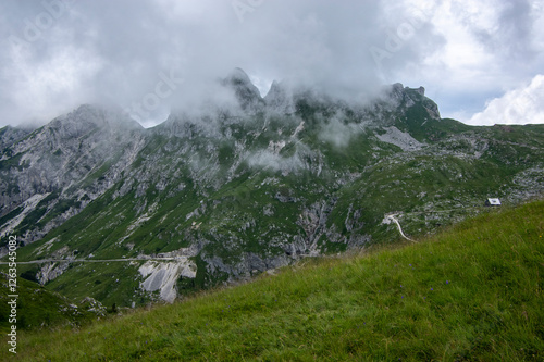 Obraz na płótnie Mala Spice Cime Verdi peaks view from Mangart saddle, Slovenia's Highest Panoramic Road, heavy clouds before rain, foggy day w salonie