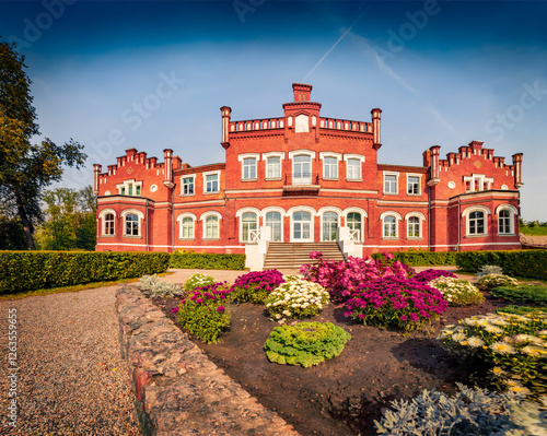 Colorful morning view of old red brick Mezmuiza castle, Latvia, Europe. Incredible summer scene of Augstkalne village, Dobele Municipality, Latvia, Europe. Traveling concept background. photo