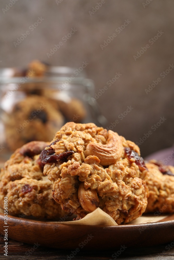 Delicious oatmeal cookies with raisins and nuts on wooden table, closeup Delicious oatmeal cookies with raisins and nuts on wooden table, closeup