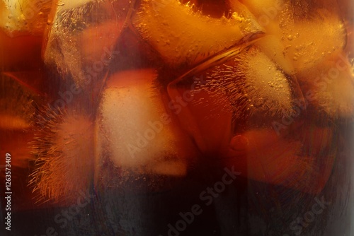 Refreshing coffee with ice cubes as background, closeup